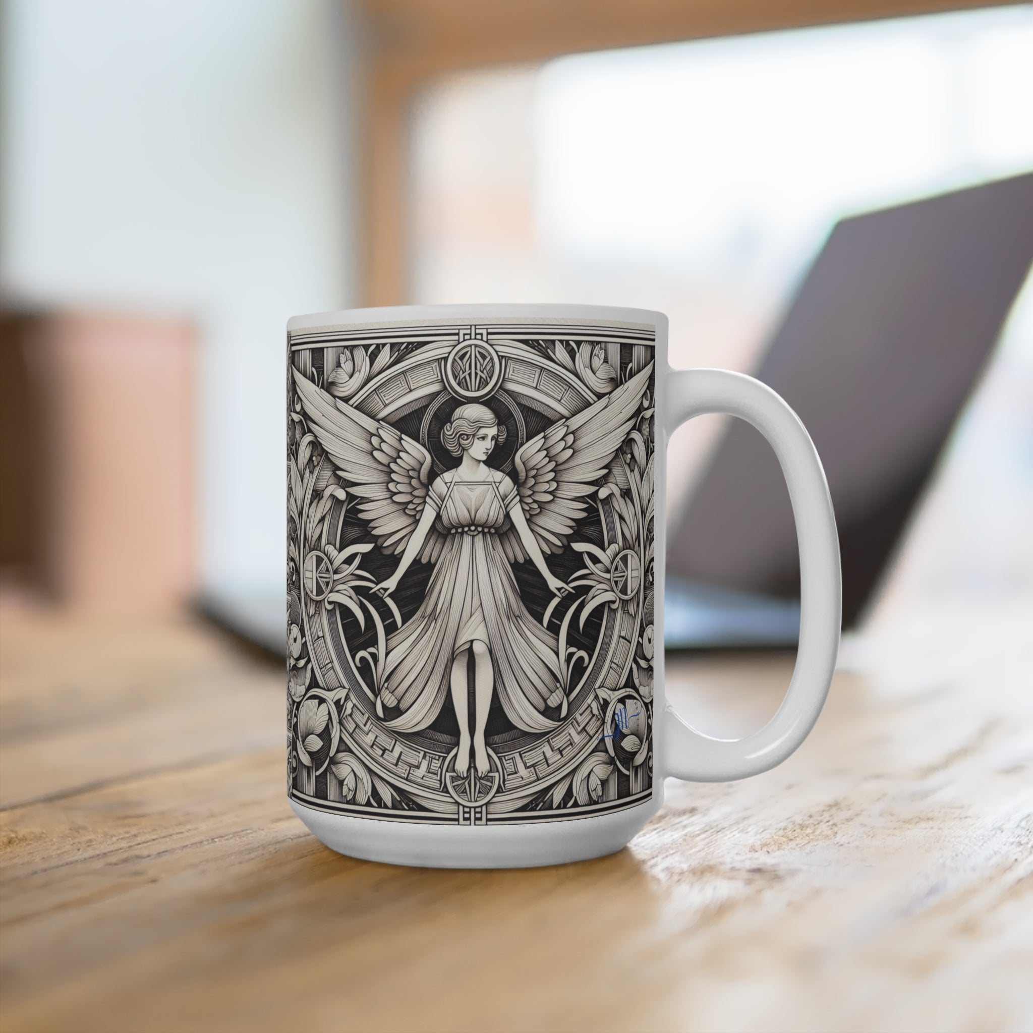 White mug with black angel design on a wooden surface