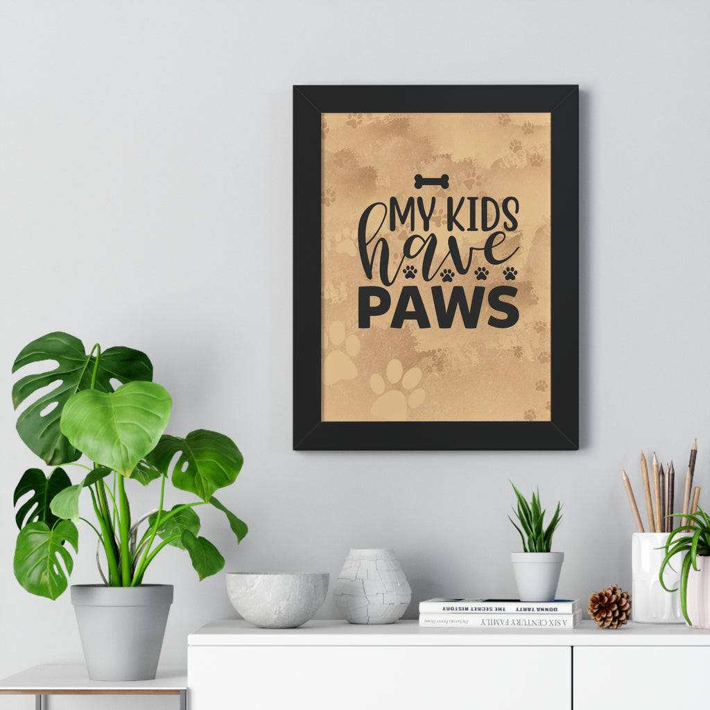 Framed print with 'My kids have paws' text on a wall above a white cabinet with plants and decor.