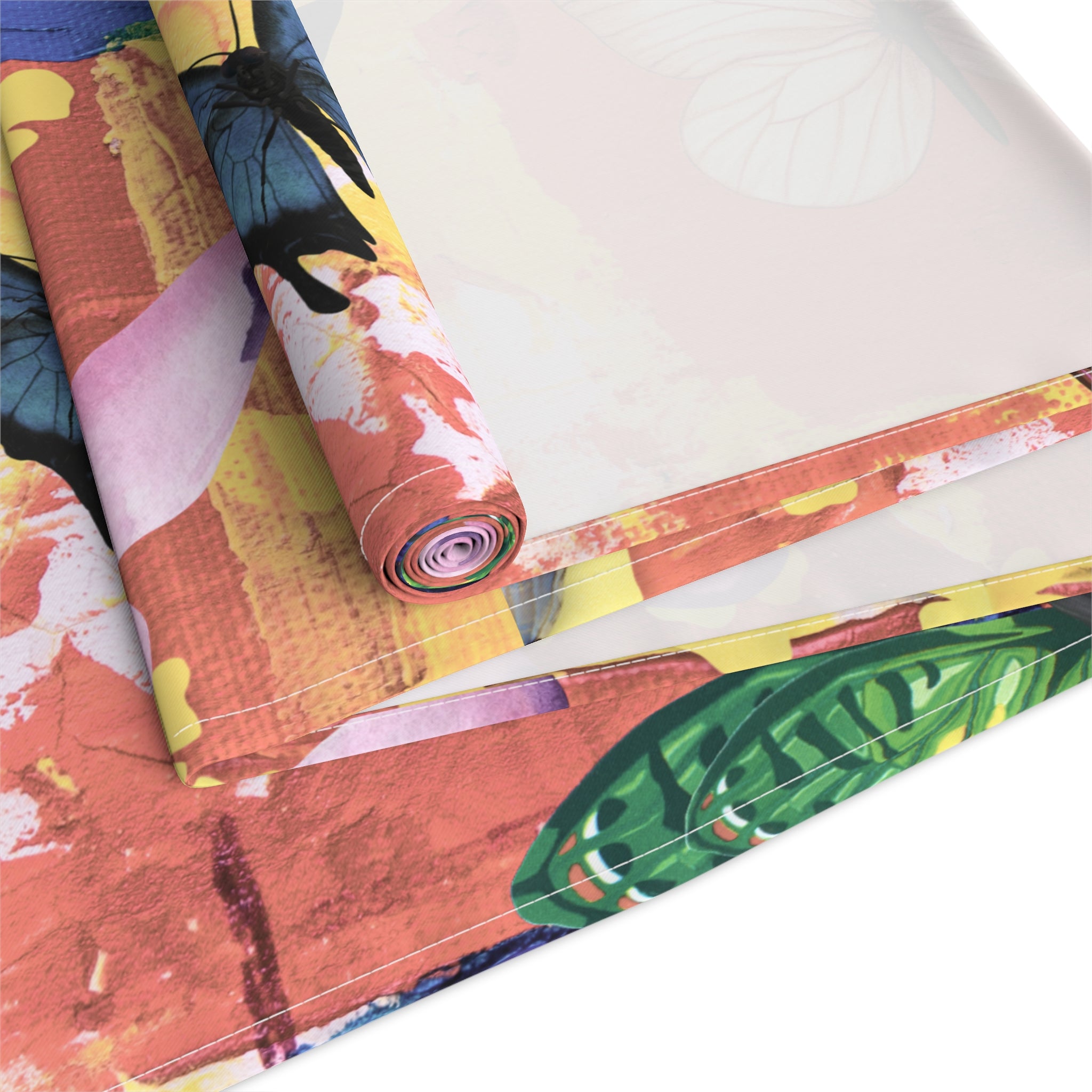 Roll of colorful fabric with abstract patterns on a white surface