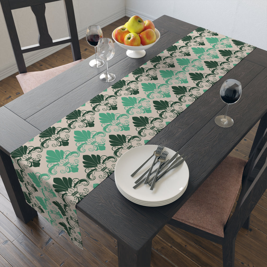Dining table with a patterned table runner, plates, cutlery, and fruit.