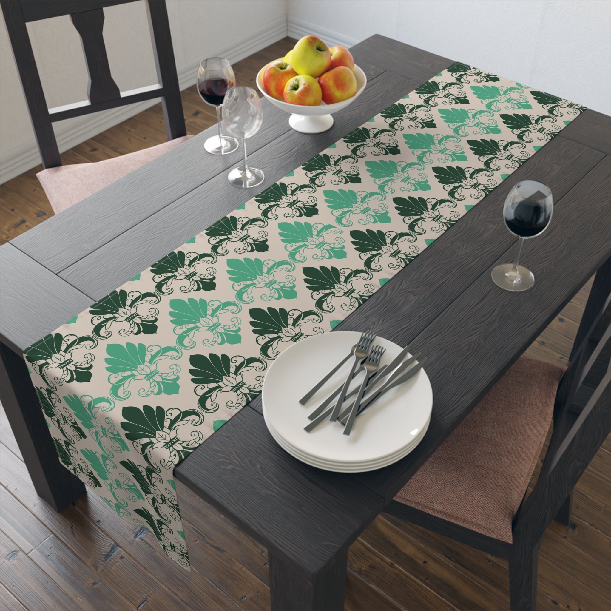 Dining table with a patterned table runner, plates, cutlery, and fruit.