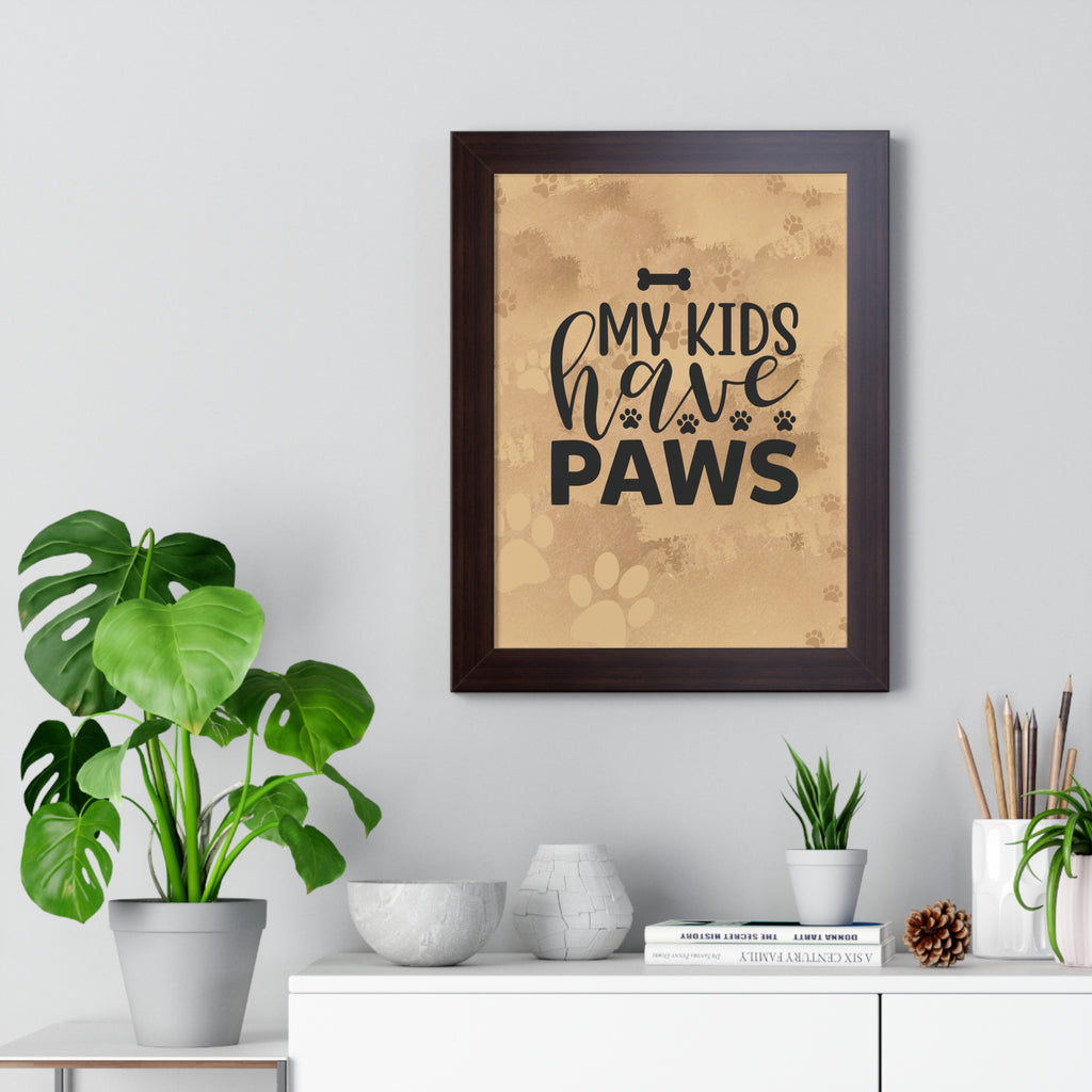 Framed print with 'My kids have paws' text on a wall above a white cabinet with plants and decor.