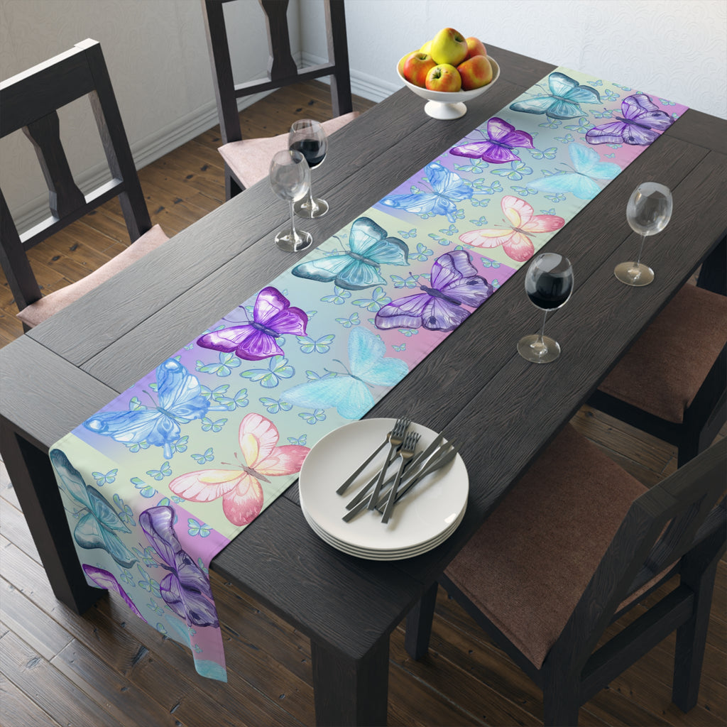Dining table with a colorful butterfly-patterned table runner, plates, and glasses.