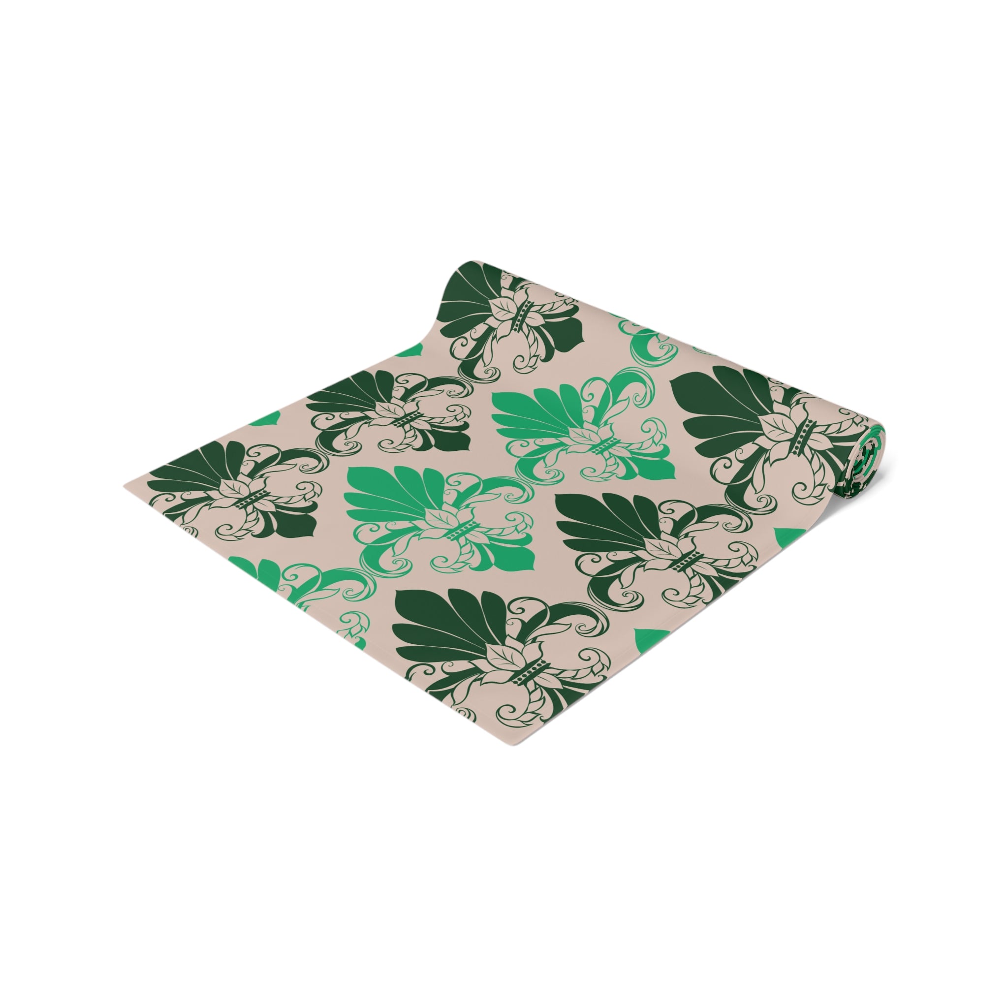 Folded fabric with green leaf pattern on a beige background
