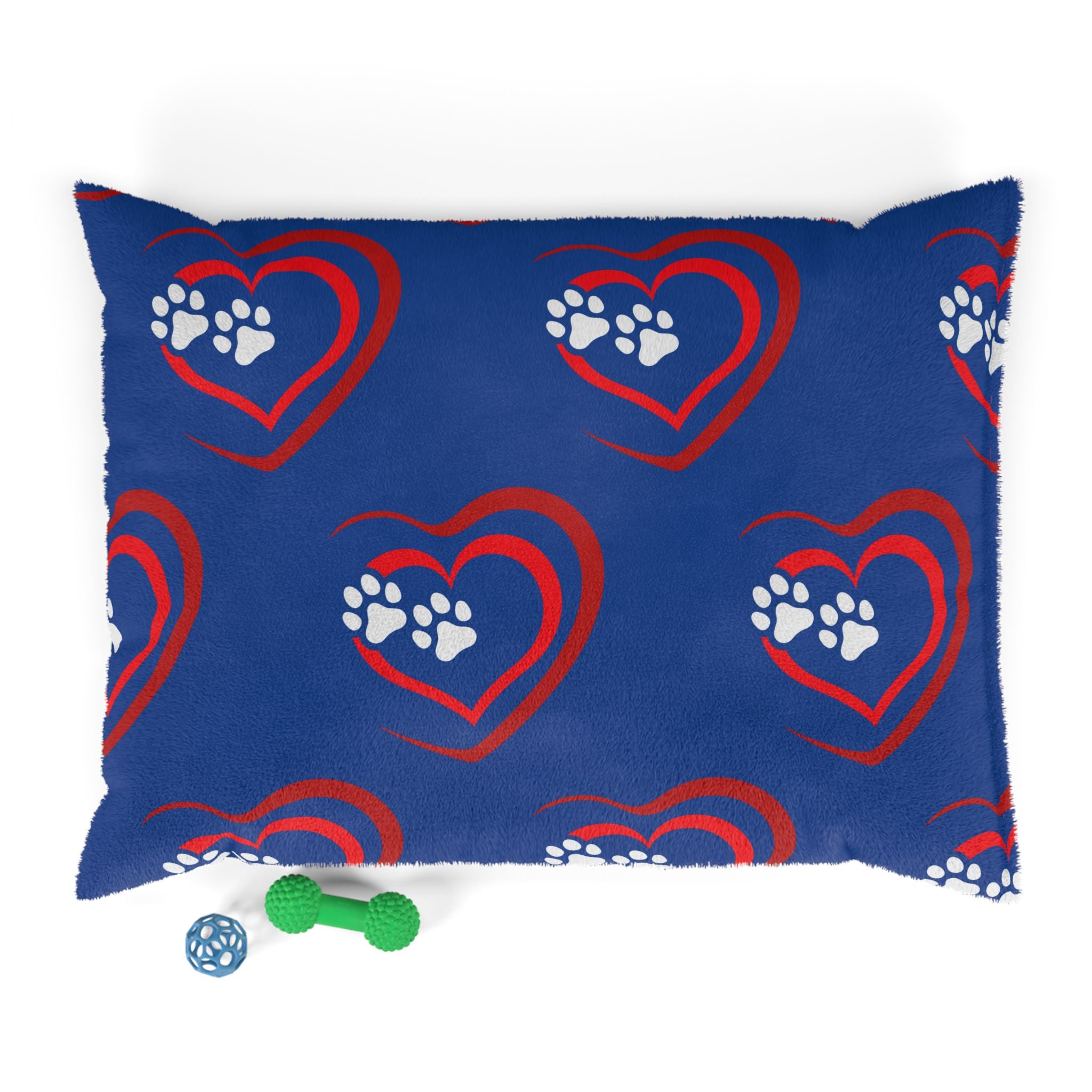 Blue pillow with red heart and white paw prints on a white background