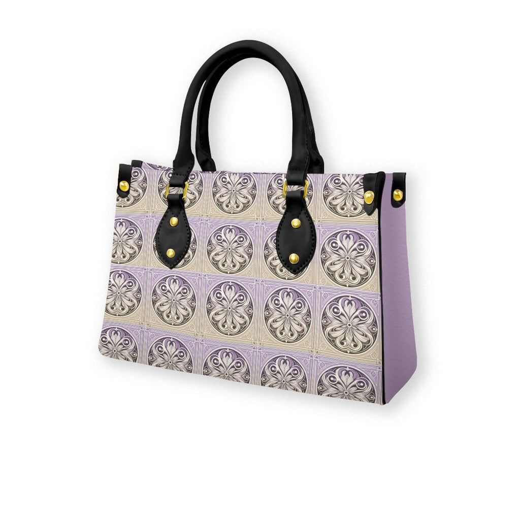 Handbag with decorative pattern and black handles on a white background