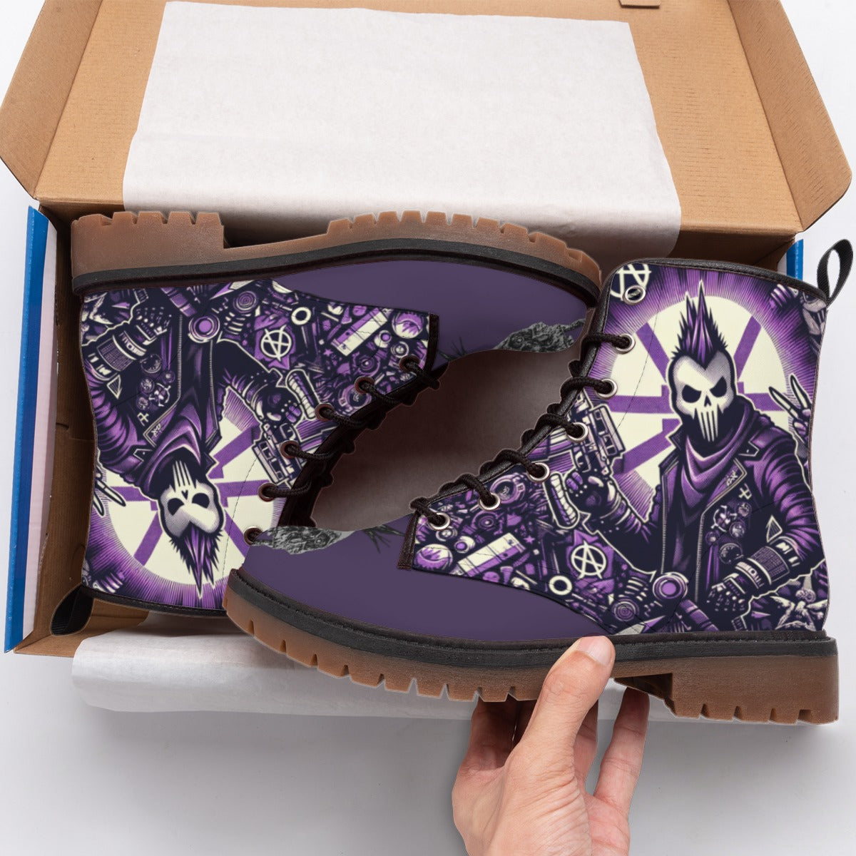 Purple and brown boots with skull design held above an open box
