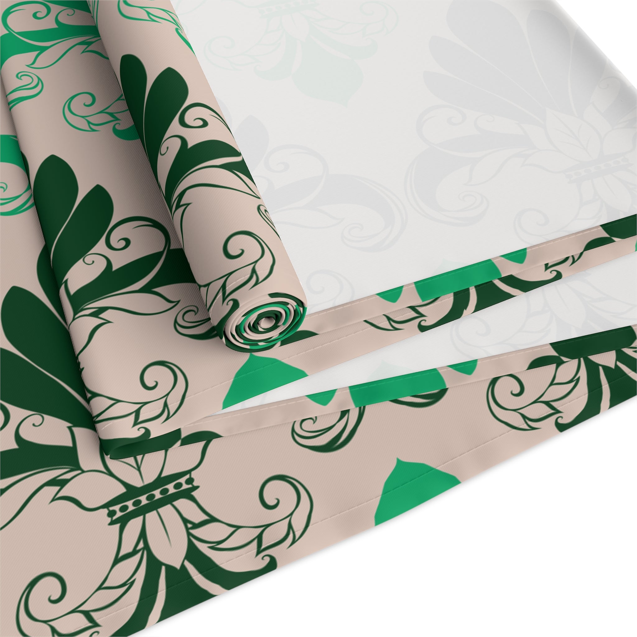 Roll of green and beige patterned paper on a white surface