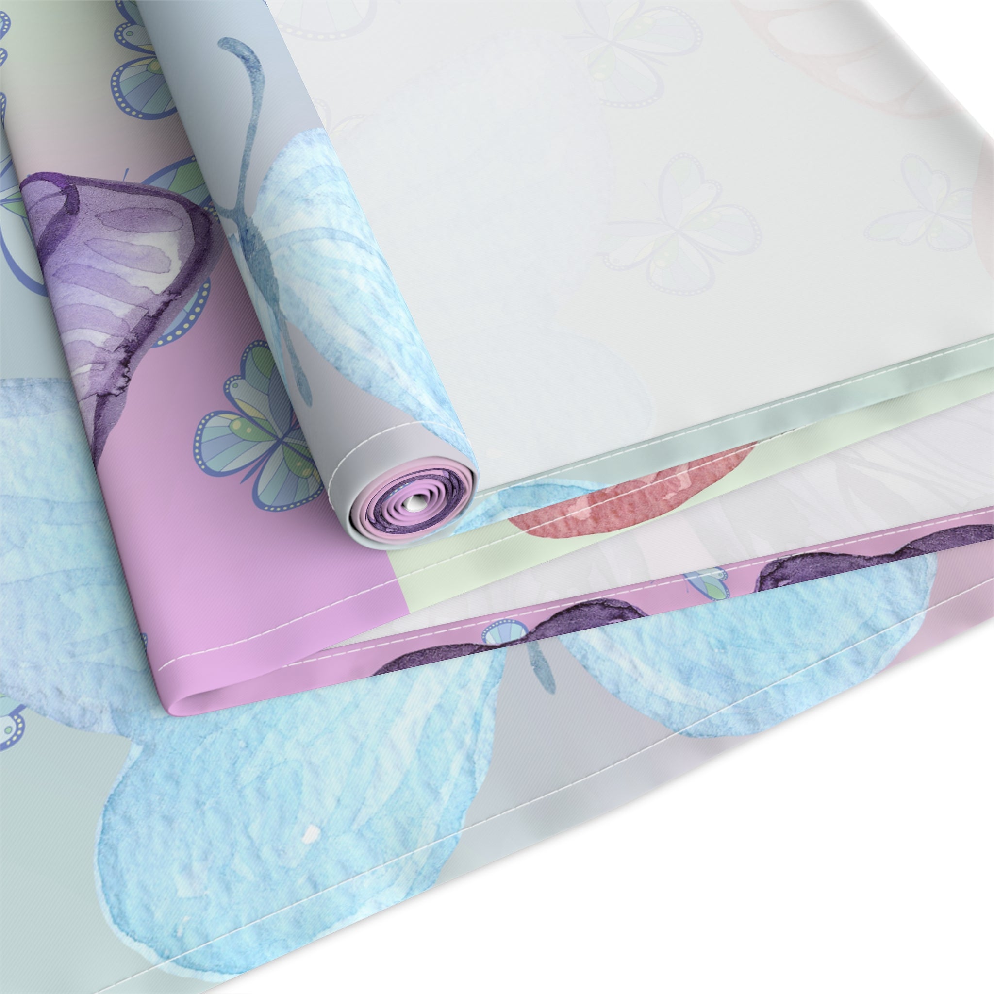 Rolls of colorful butterfly-patterned paper on a white background