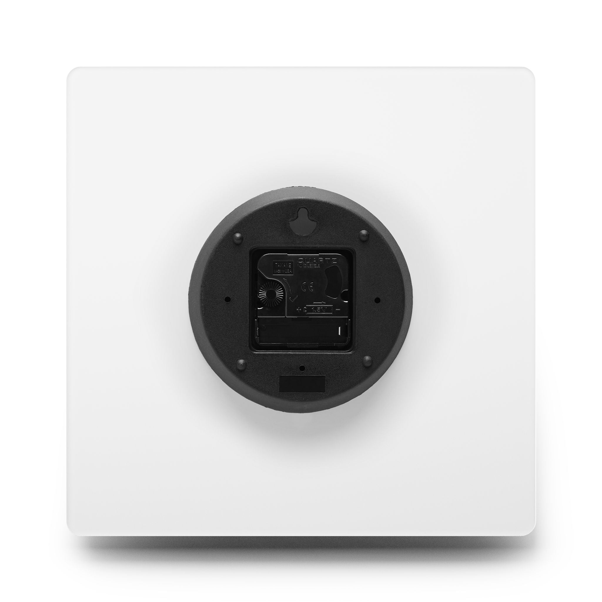 Round black device on a white square base with a white background