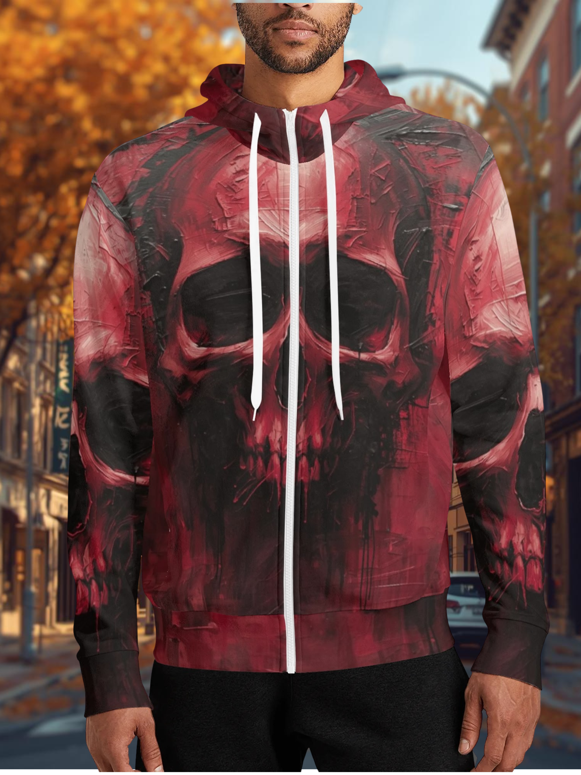 Person wearing a red and black hoodie with a skull design outdoors.