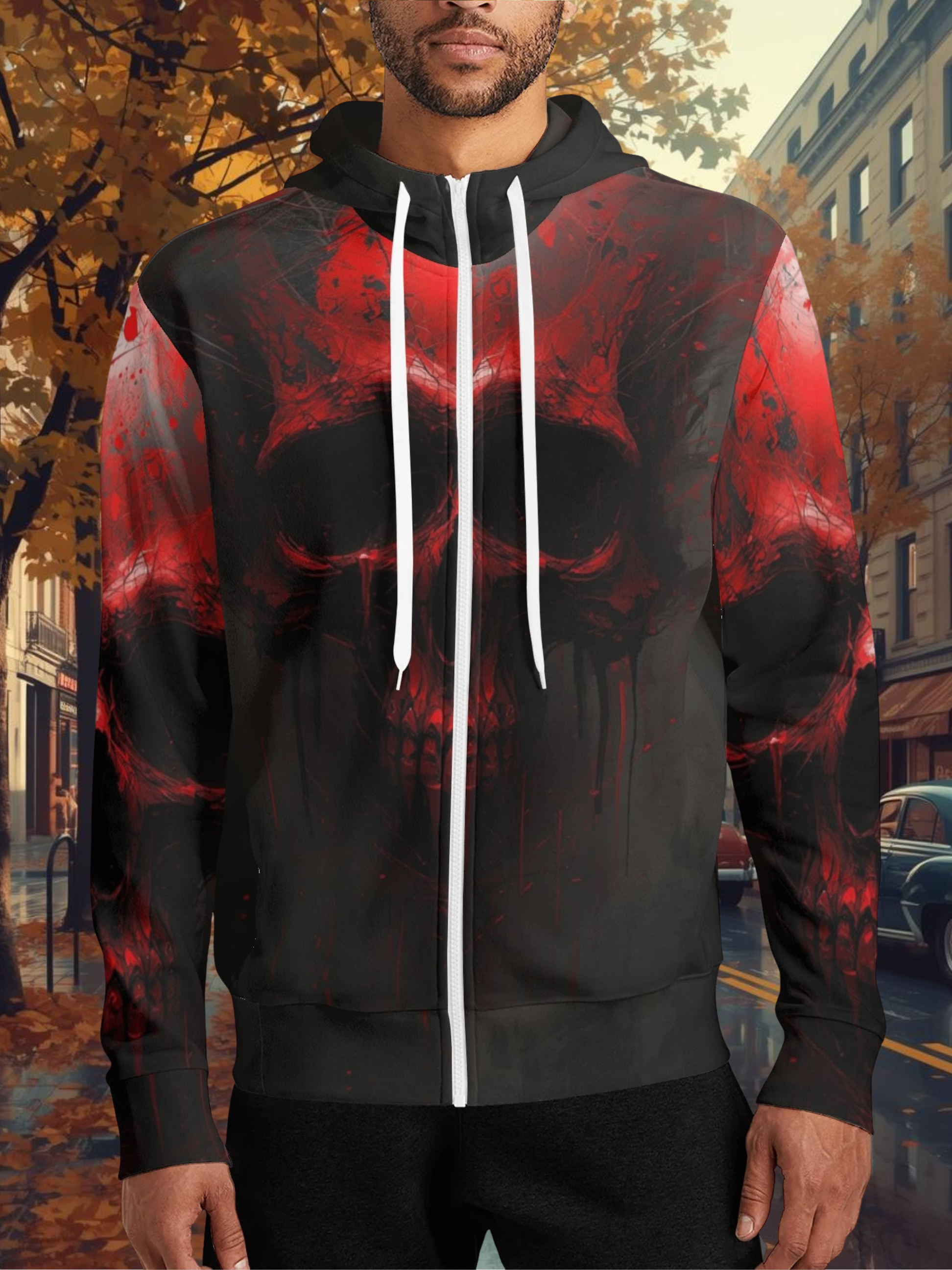 Person wearing a black and red hoodie with a skull design on an urban street background