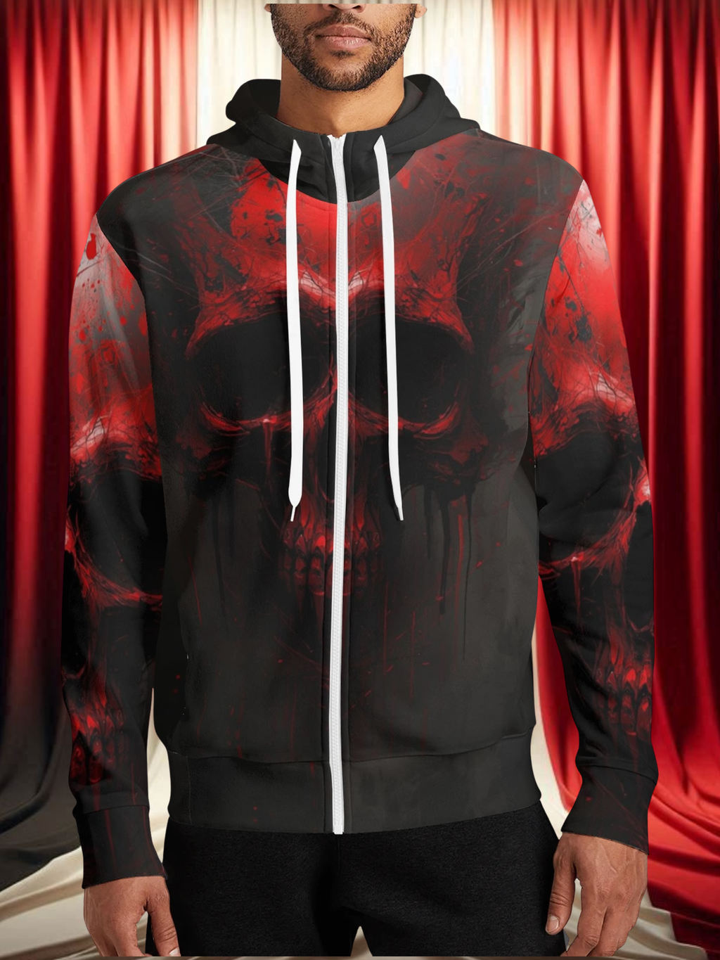 Person wearing a black hoodie with red abstract design against a red curtain background