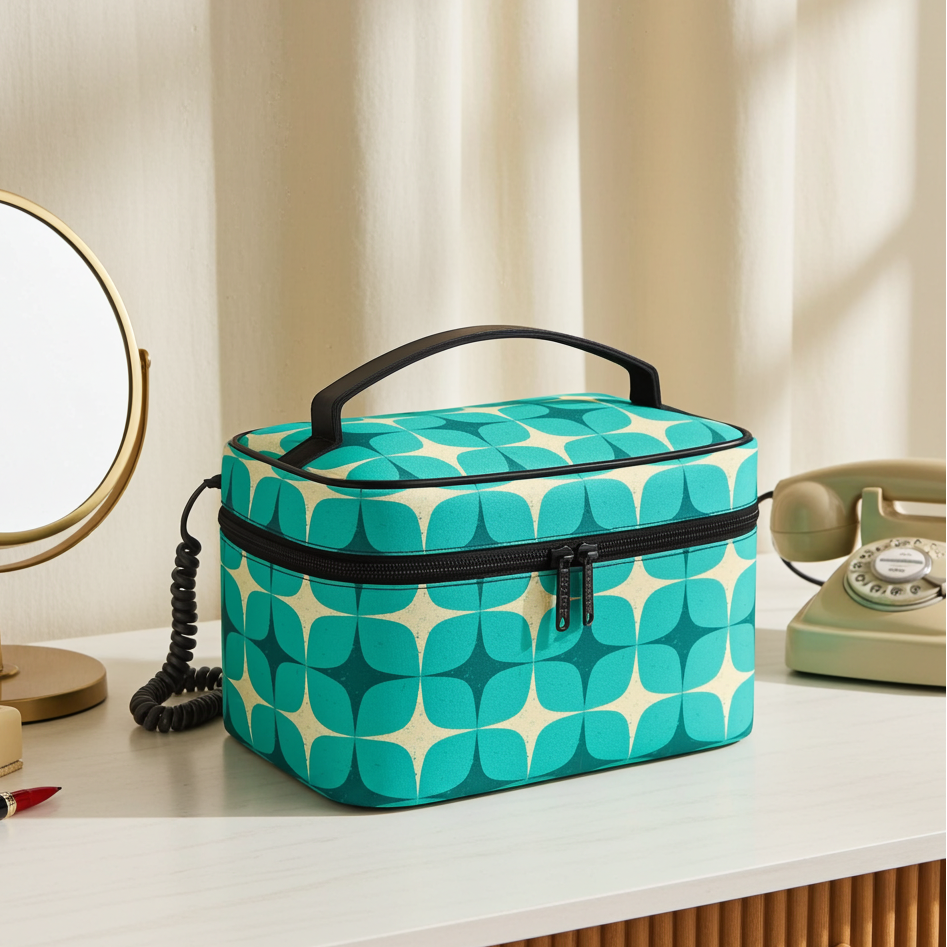 Teal patterned cosmetic bag on a vanity table with mirror and phone.