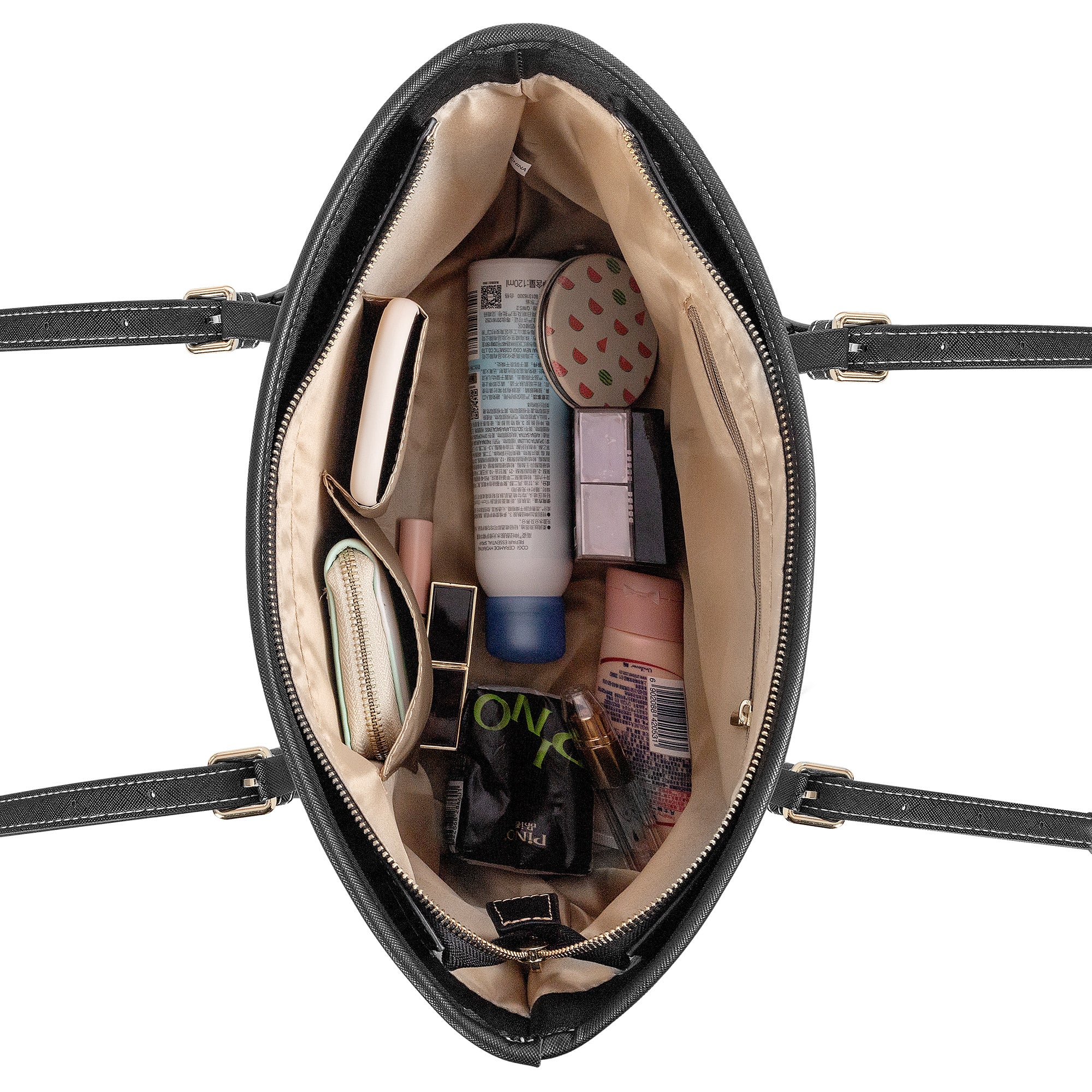 Black handbag open to reveal beauty products on a white background