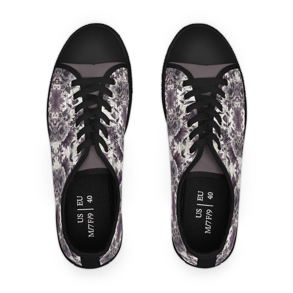 Pair of black sneakers with floral pattern on a white background