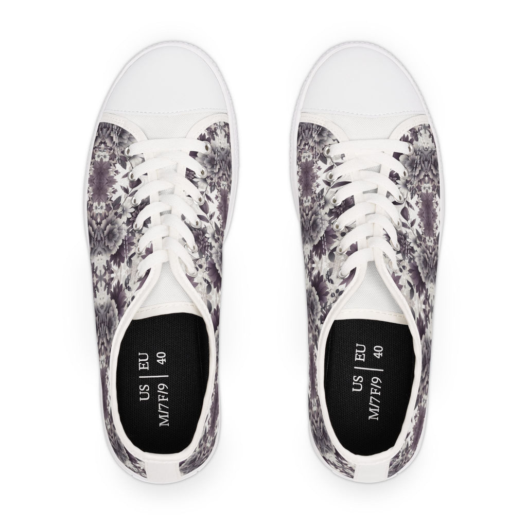 Pair of white sneakers with black and gray floral pattern on a white background
