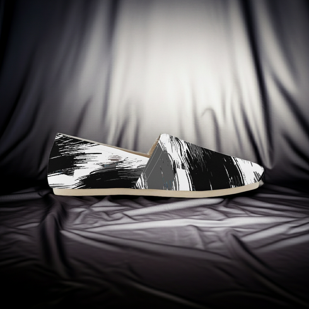 Black and white patterned shoes on a draped fabric background