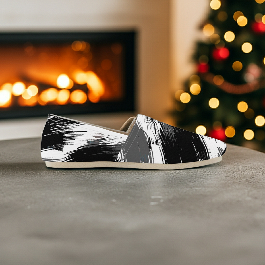 Black and white patterned slip-on shoe on a surface with a fireplace and Christmas tree in the background