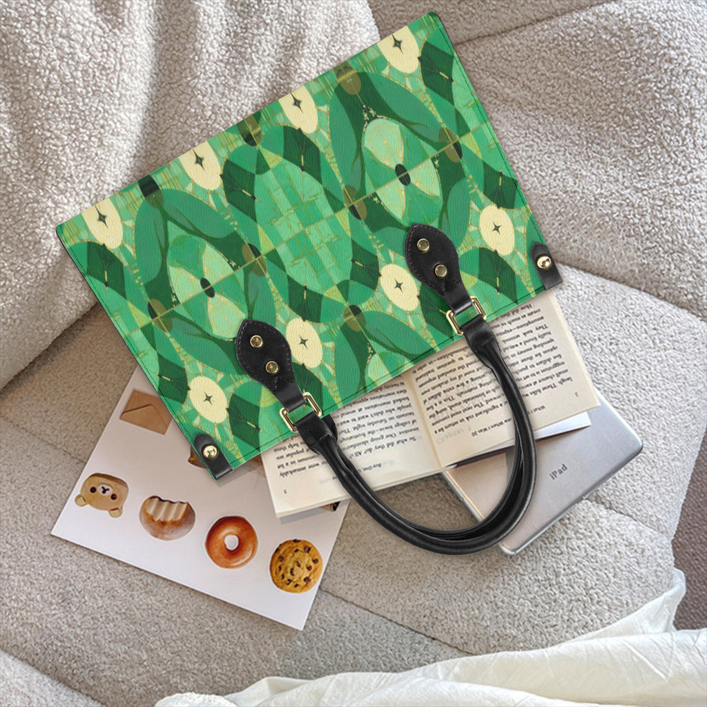 Green patterned bag with black handle on a textured surface