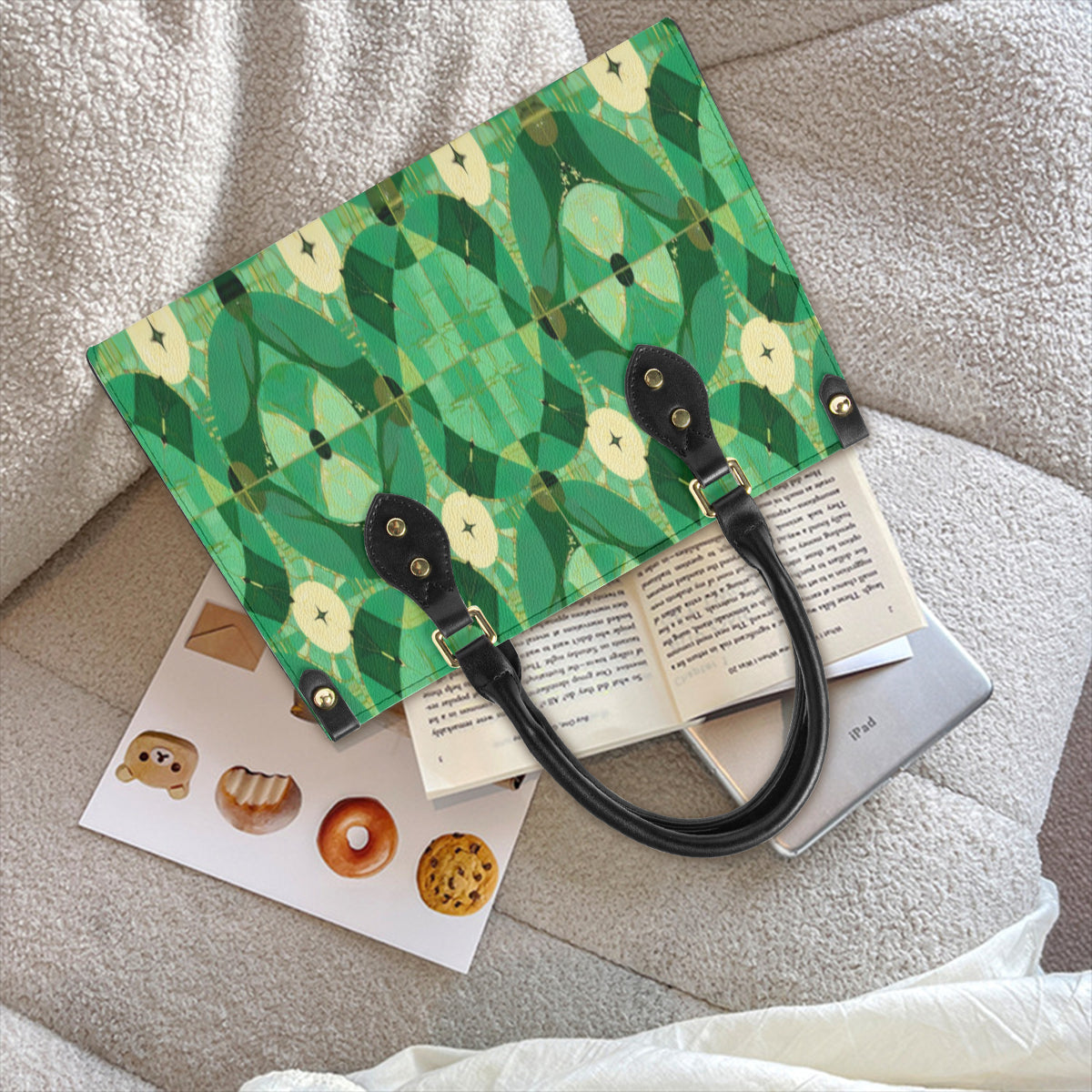 Green patterned bag with black handle on a textured surface