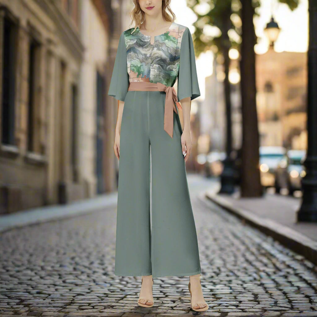 Woman wearing a green floral top and wide-leg pants on a white background