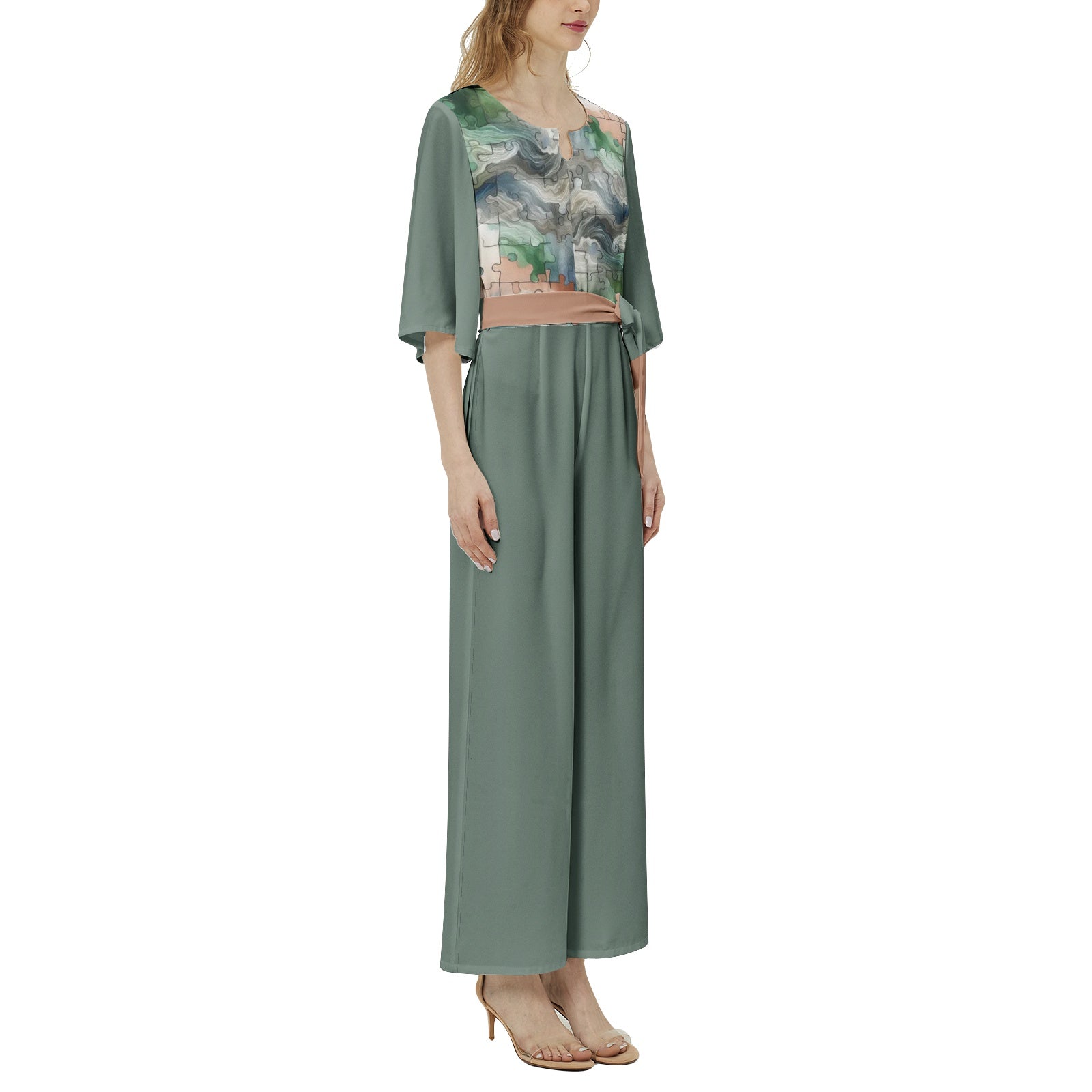 Woman wearing a green dress with a floral pattern on a white background